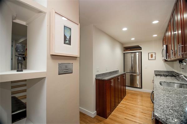 116 Charles Street, Unit 1 Boston, MA 02114 - Photo 4 of 8 a kitchen with stainless steel appliances granite countertop a refrigerator a stove and a sink