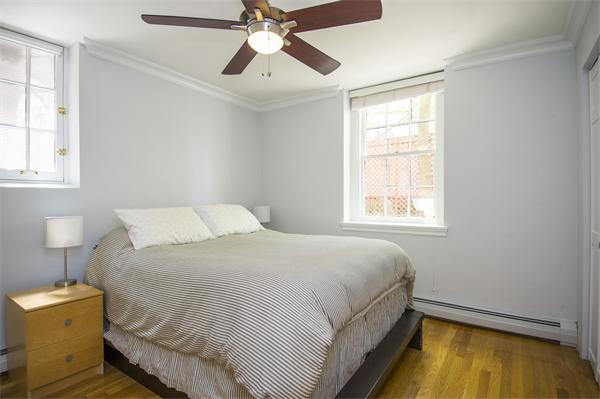 116 Charles Street, Unit 1 Boston, MA 02114 - Photo 5 of 8 a bedroom with a bed and a window
