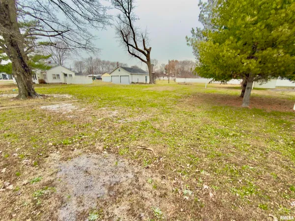 a view of yard with swimming pool and trees