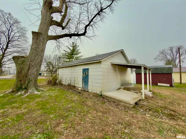 a house that has a tree in front of it