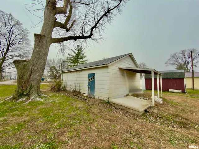 a house that has a tree in front of it