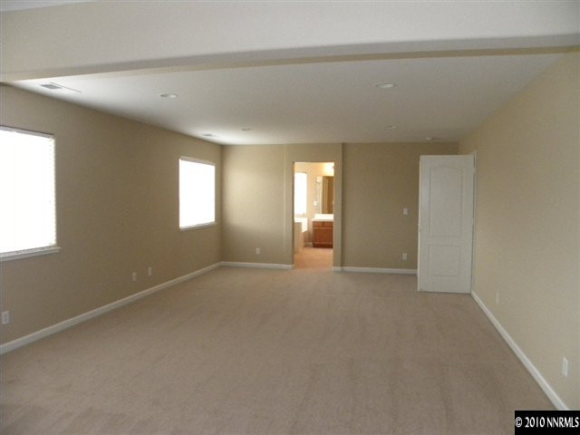 10833 Rushing Flume Drive Reno, NV 89521 - Photo 7 of 12 an empty room with windows and closet