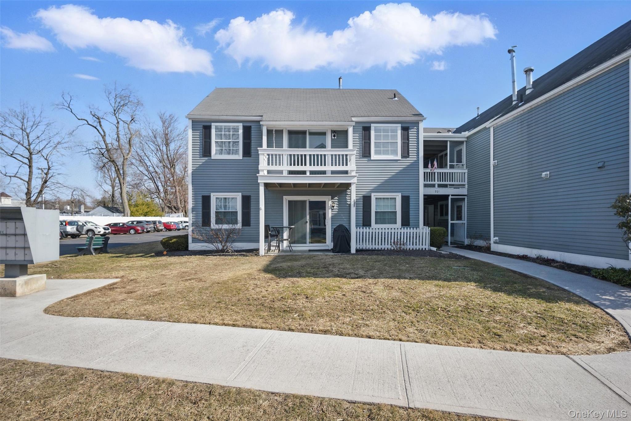 201 Commons Way, Unit E Fishkill, NY 12524 - Photo 3 of 30 Traditional-style house with a front yard and a balcony