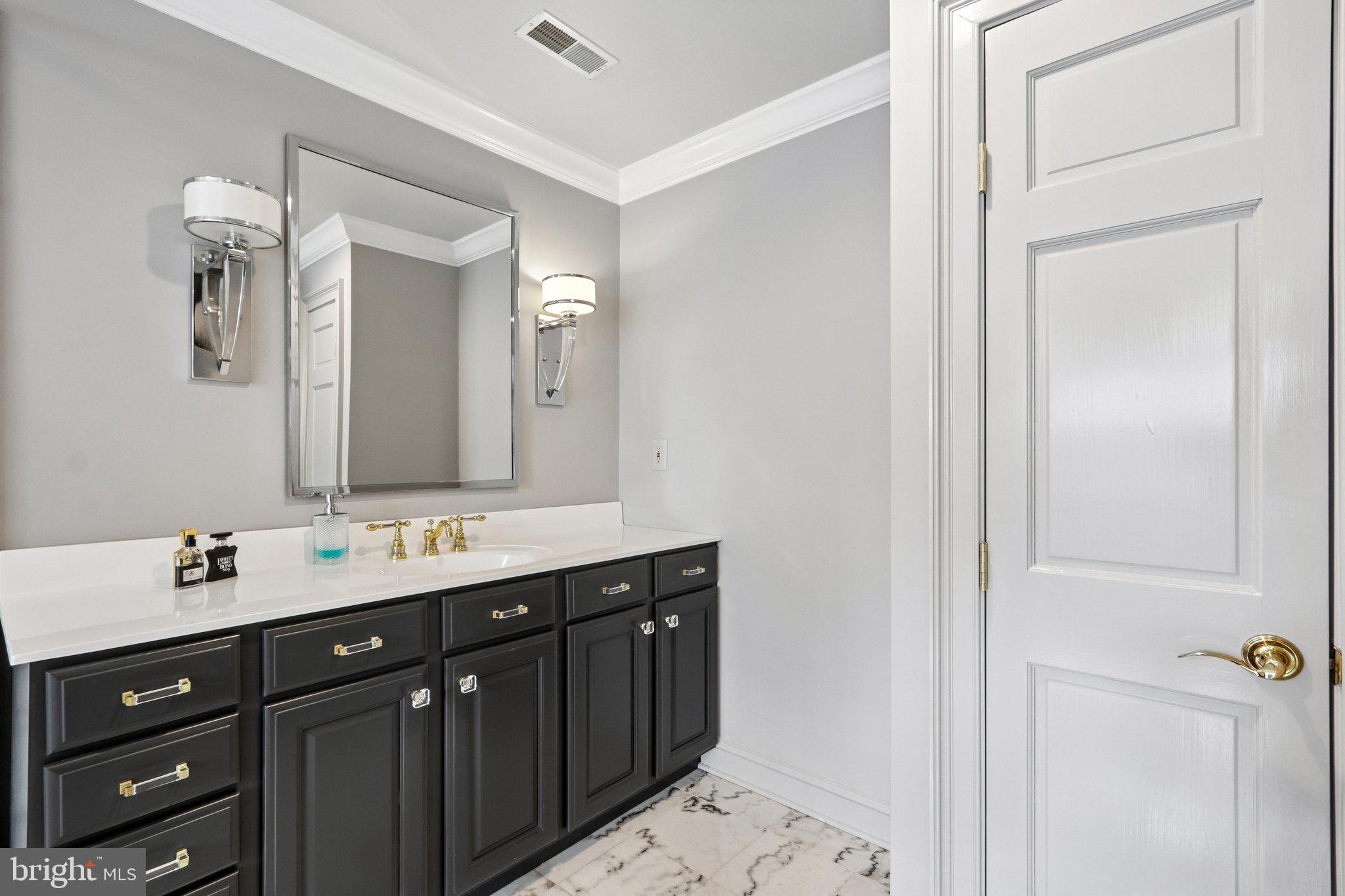209 Welsh Road Ambler, PA 19002 - Photo 41 of 80 a bathroom with a double vanity sink and mirror
