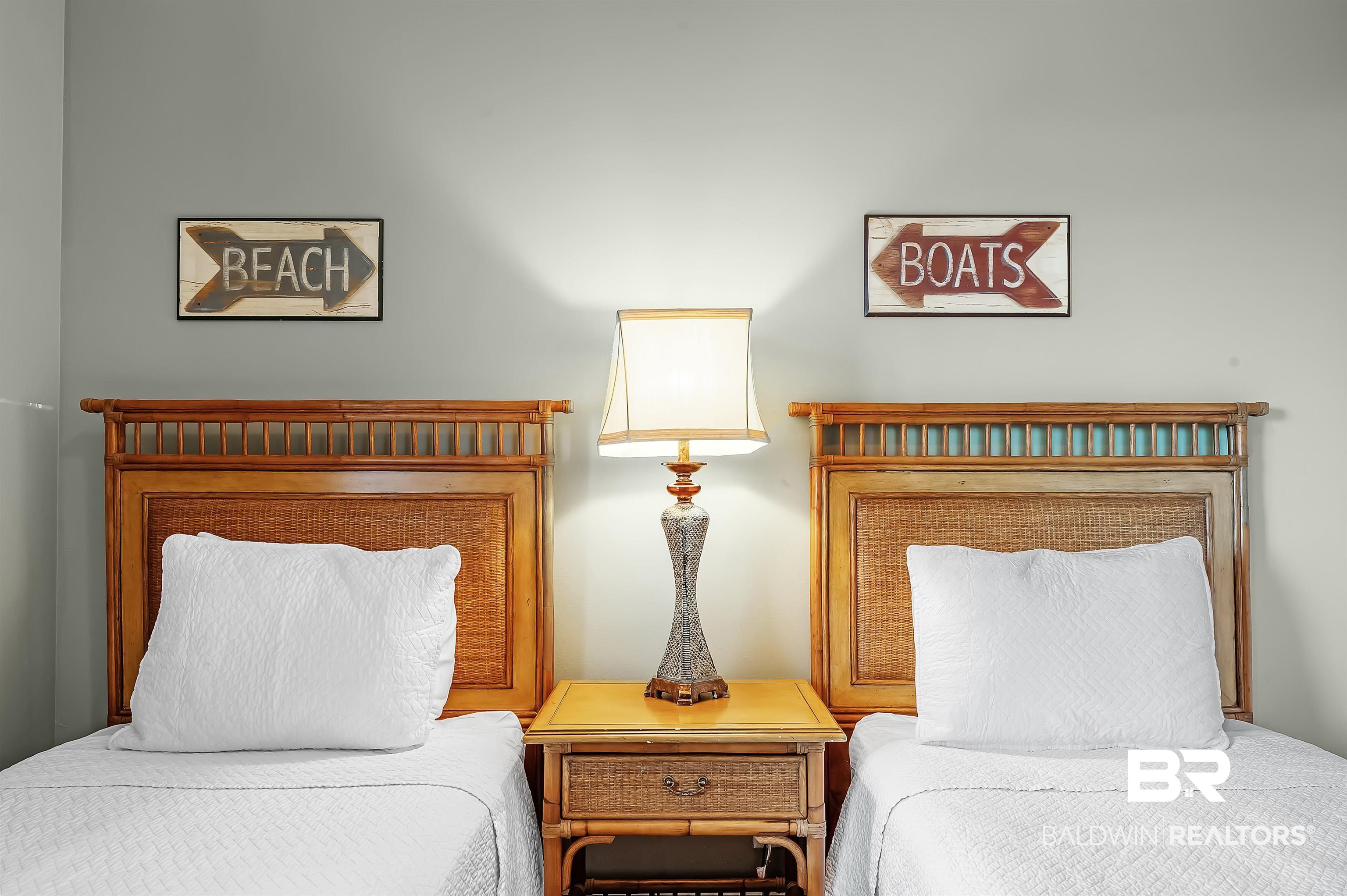 16287 Perdido Key Drive, Unit 105 Pensacola, FL 32507 - Photo 36 of 66 Two twin beds featuring woven rattan headboards