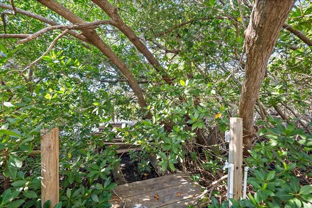 a view of a dining room with furniture wooden floor and a floor to ceiling window