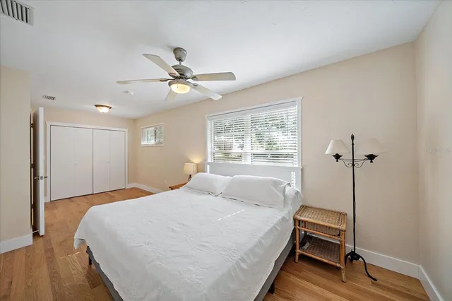 a bedroom with a large bed and a chandelier