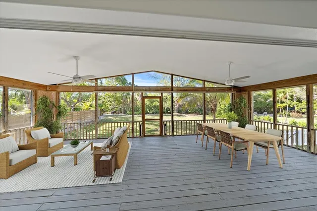 a view of a dining room with furniture large windows and wooden floor
