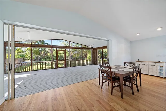 a view of a dining room with furniture window and wooden floor