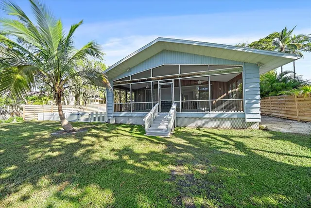 a front view of a house with a yard table and chairs