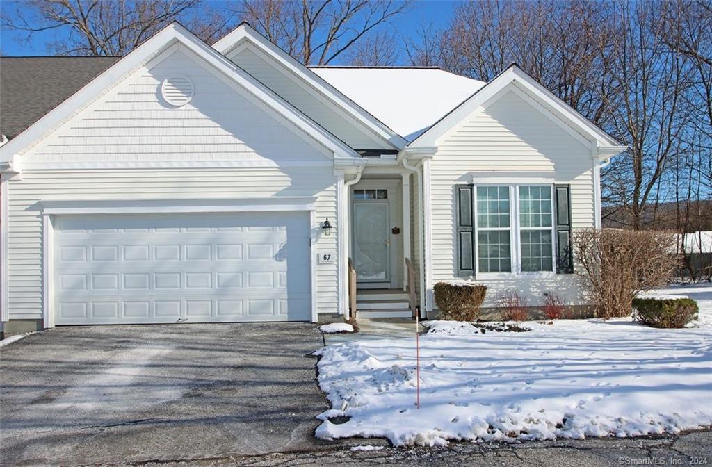 a front view of a house with a yard and seating space