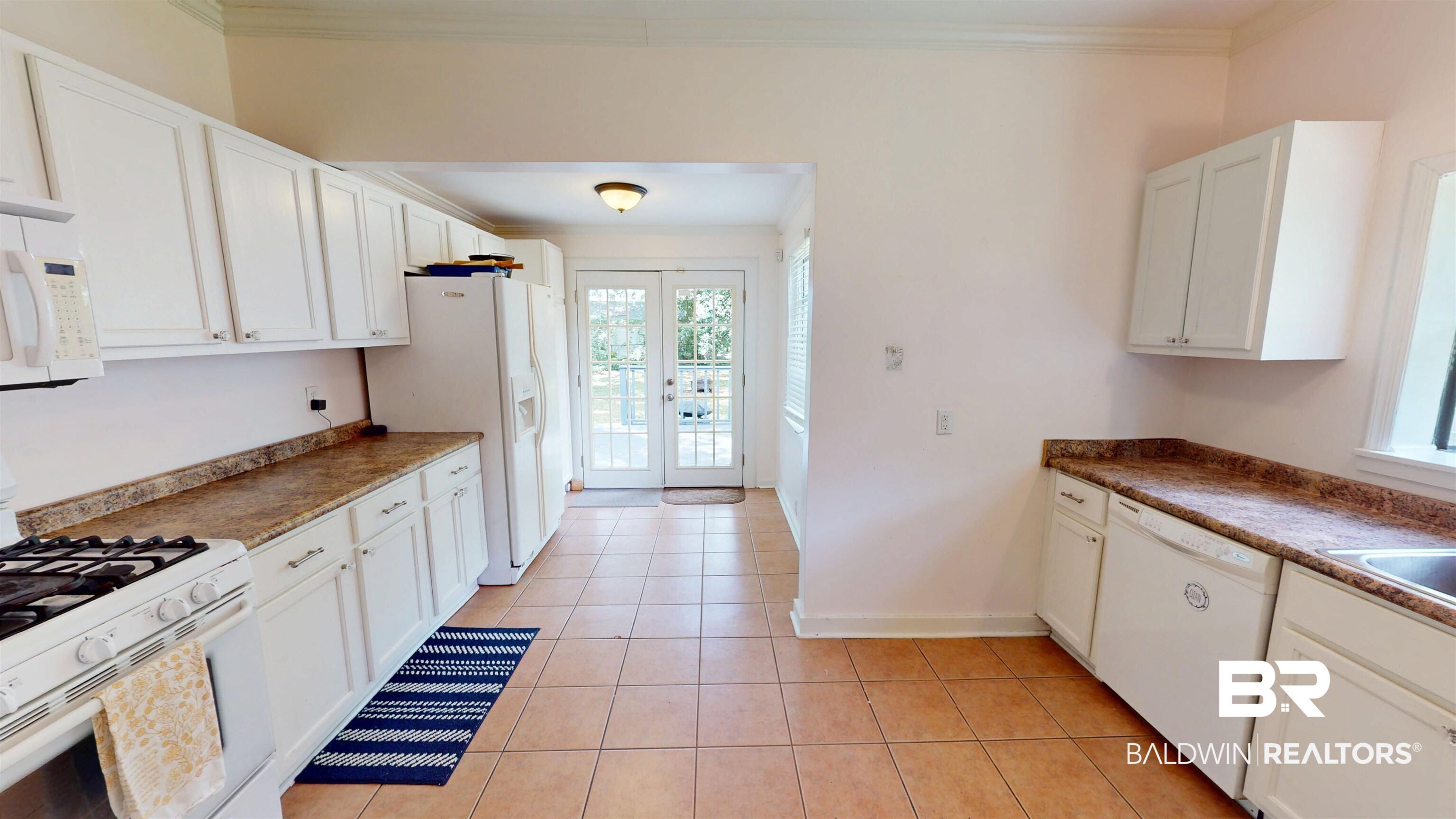 266 Westwood Street Mobile, AL 36606 - Photo 13 of 34 Kitchen with white appliances, french doors, ornamental molding, white cabinetry, and light tile patterned floors