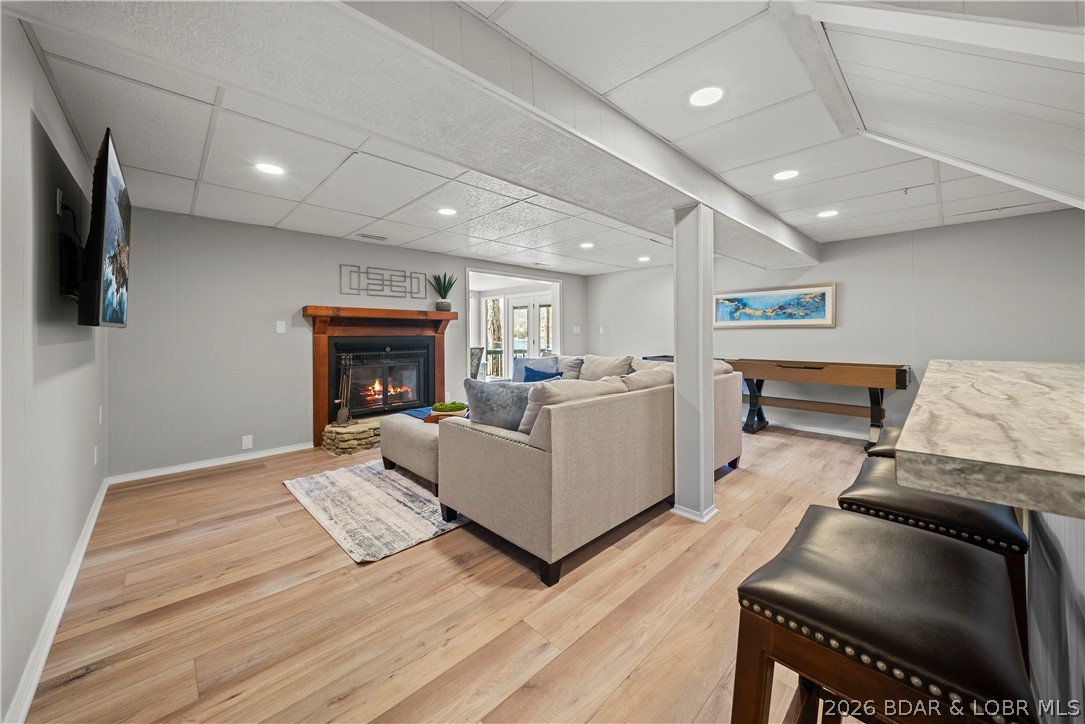 498 Wilmore Road Lake Ozark, MO 65049 - Photo 19 of 57 Cozy fireplace and shuffleboard in lower level