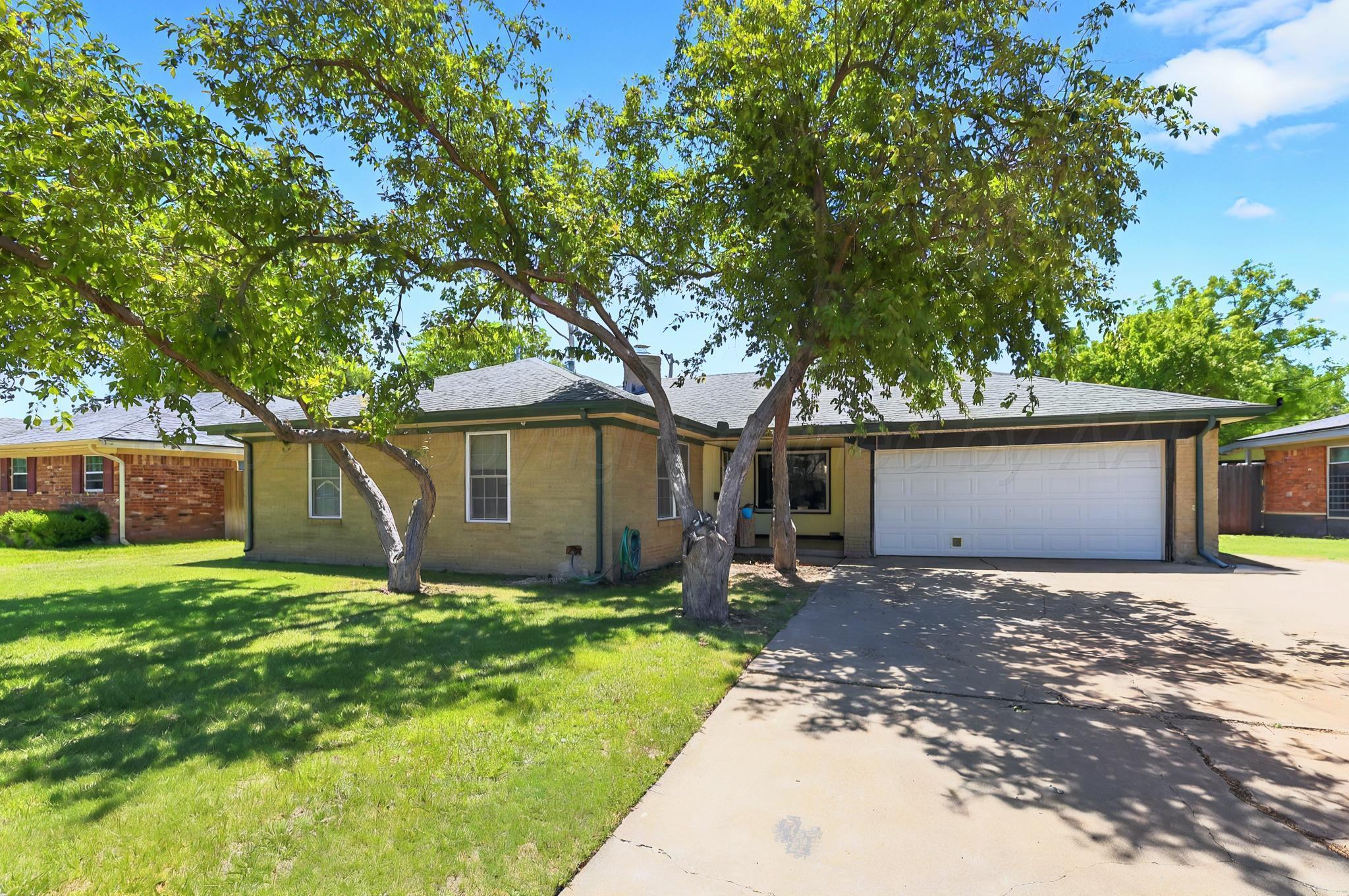 6005 Gainsborough Road Amarillo, TX 79106 - Photo 1 of 19 a front view of a house with a yard and a large tree