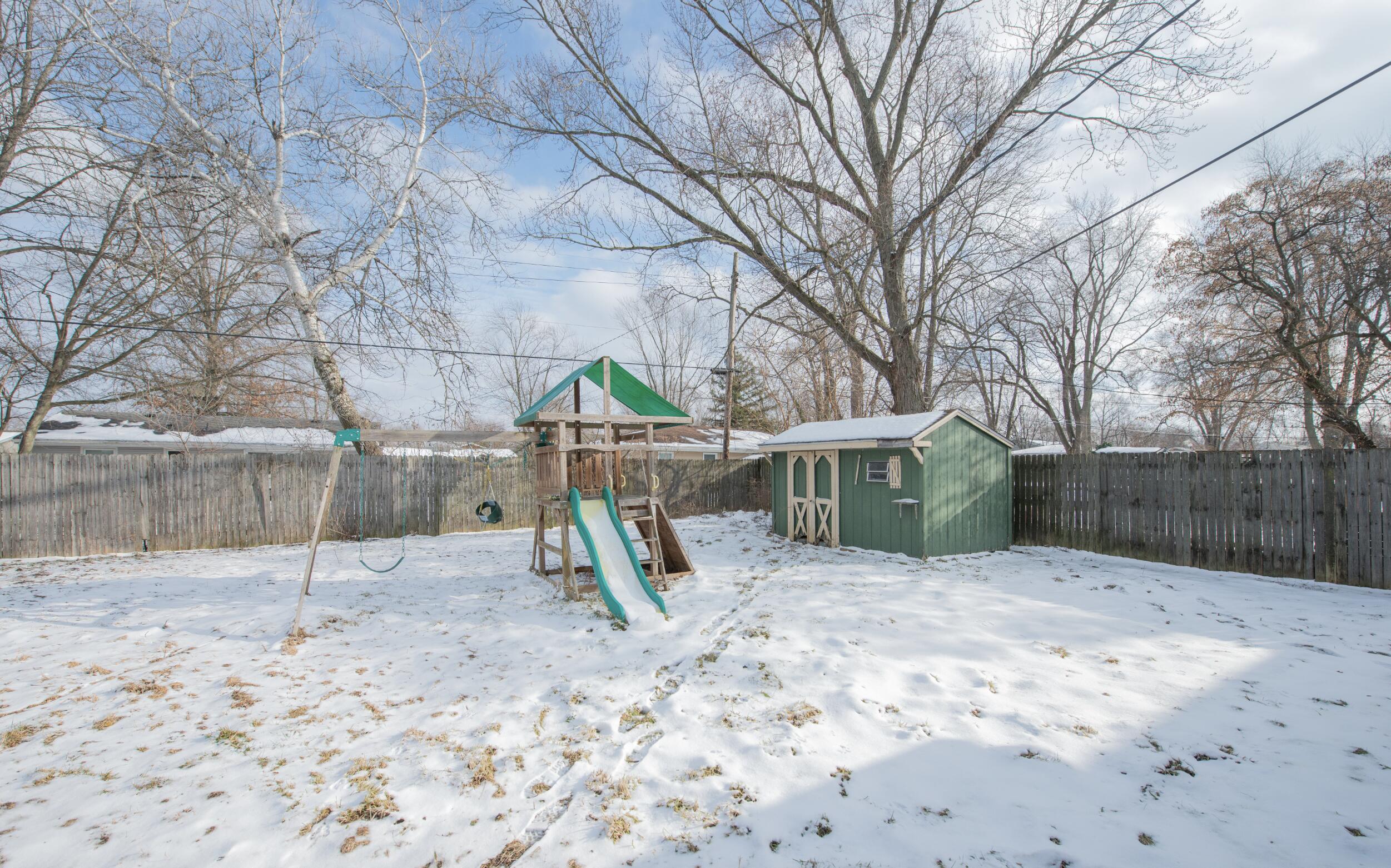 763 Timberline Parkway Valparaiso, IN 46385 - Photo 13 of 16 a view of a wooden house with a yard and swing