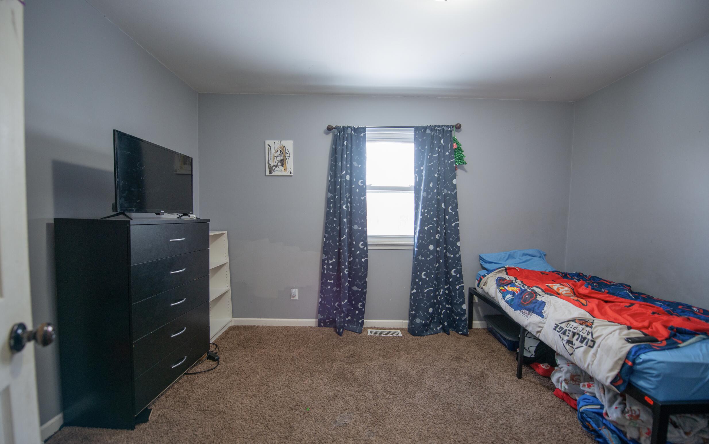 763 Timberline Parkway Valparaiso, IN 46385 - Photo 7 of 16 a bedroom with a bed and a tv