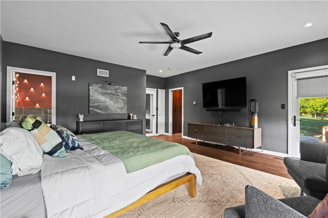 1506 Pleasant View Road Coopersburg, PA 18036 - Photo 39 of 97 Unwind in this serene primary bedroom, featuring rich hardwood floors and direct access to outdoor greenery.