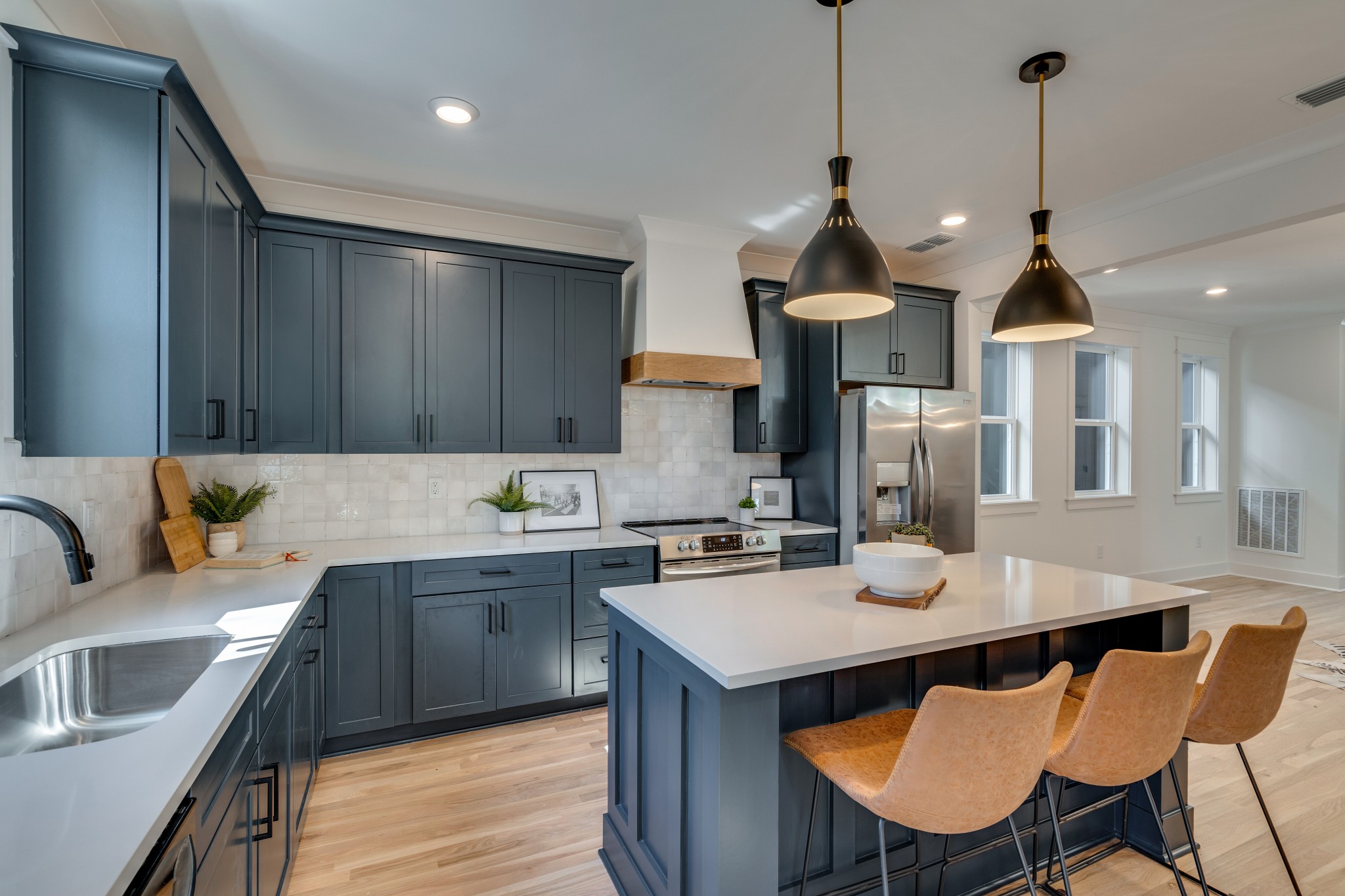 411 High Street Nashville, TN 37211 - Photo 1 of 32 a kitchen with a stove a sink a kitchen island with chairs and wooden floor