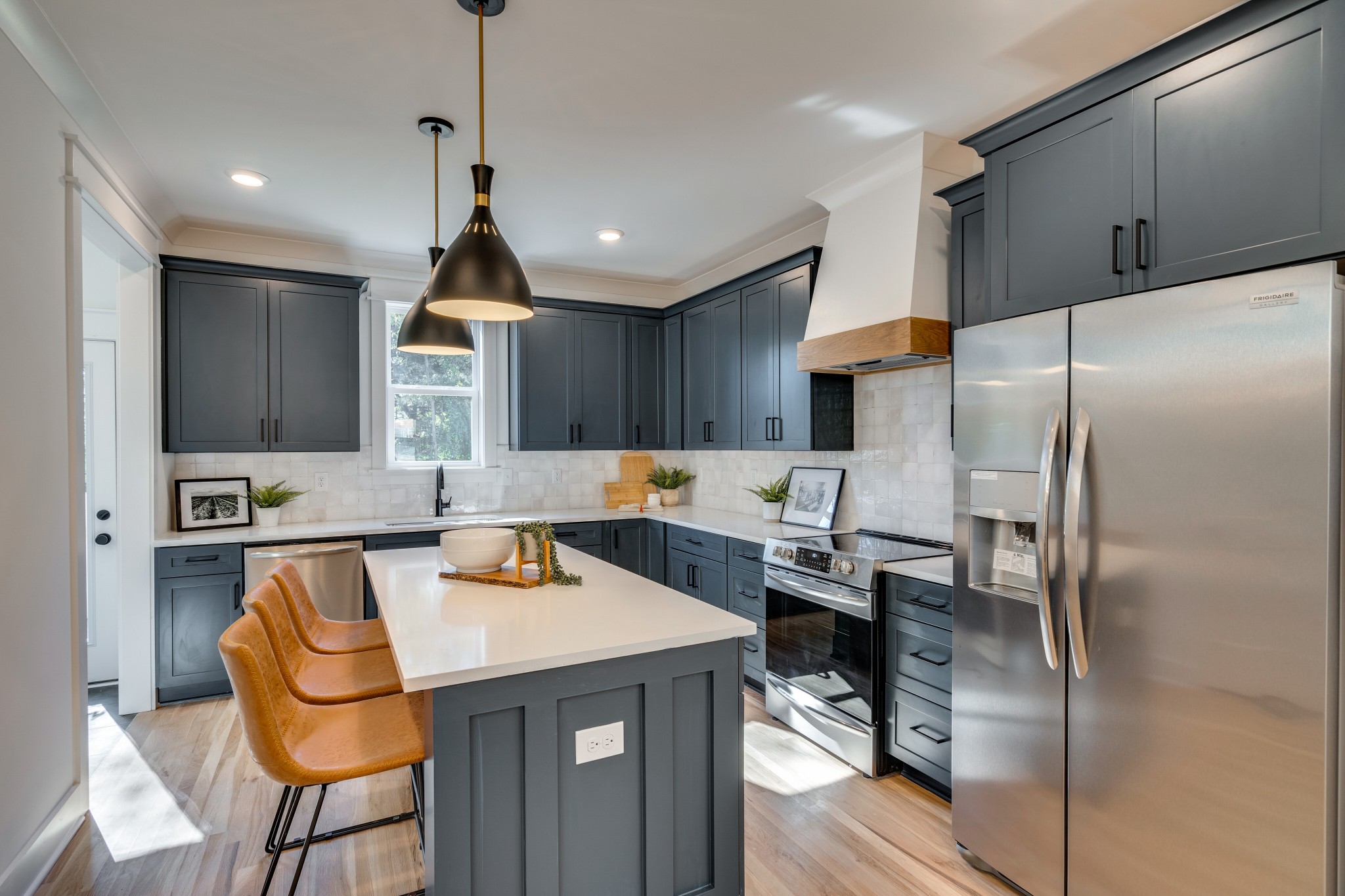 411 High Street Nashville, TN 37211 - Photo 13 of 32 a kitchen with refrigerator a sink and chairs