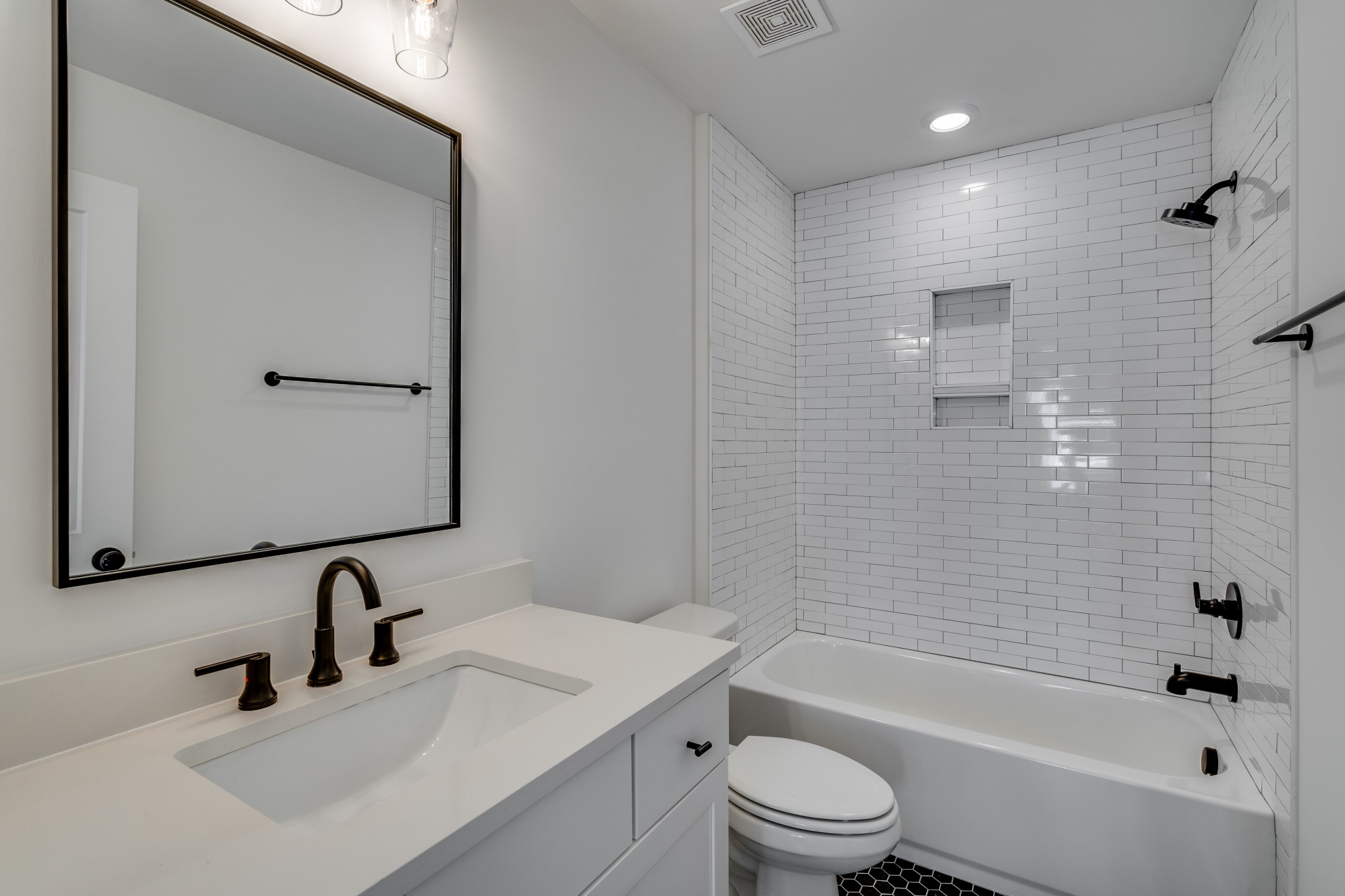 411 High Street Nashville, TN 37211 - Photo 26 of 32 a bathroom with a bathtub shower sink vanity mirror and toilet