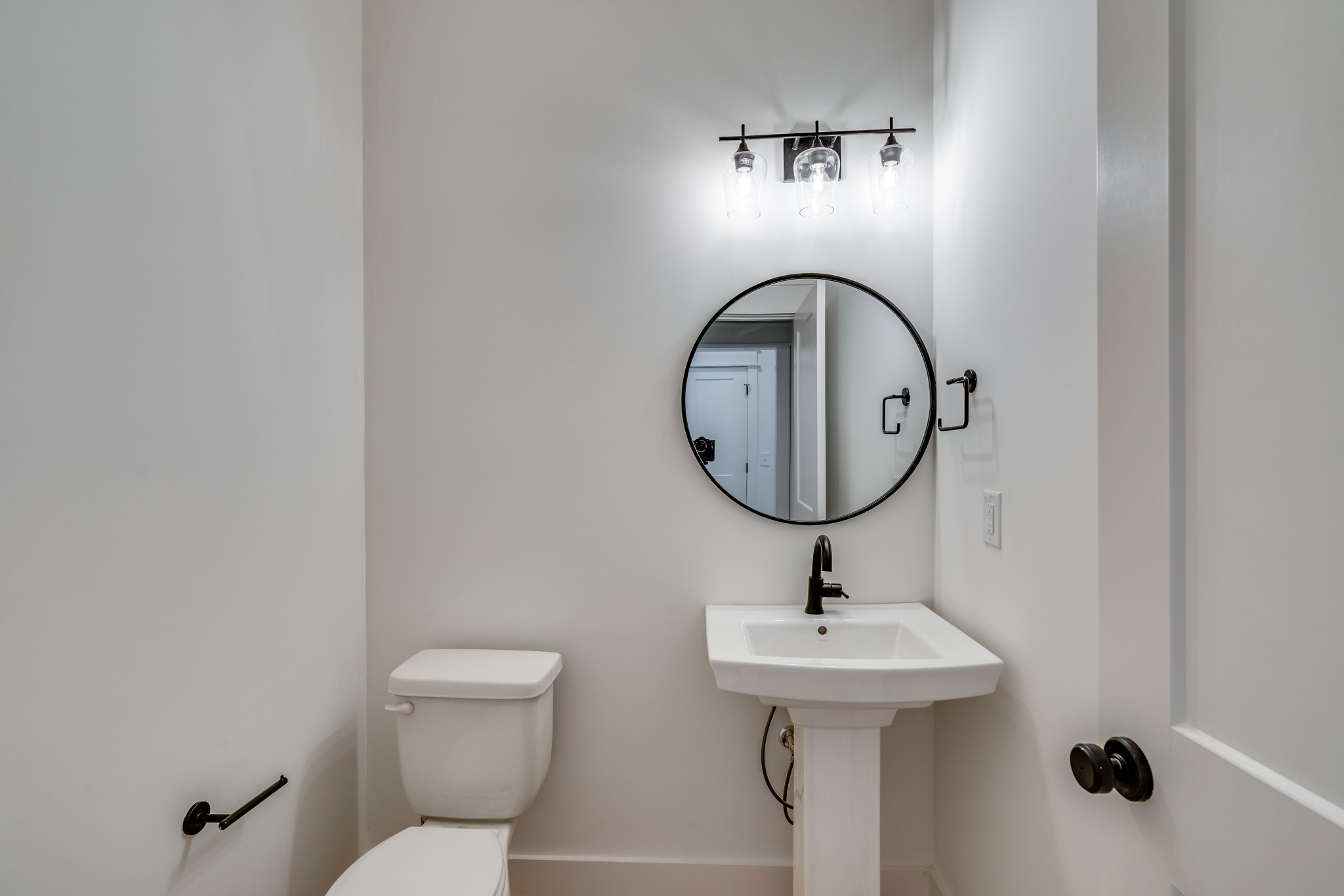 411 High Street Nashville, TN 37211 - Photo 8 of 32 a bathroom with a toilet sink and mirror