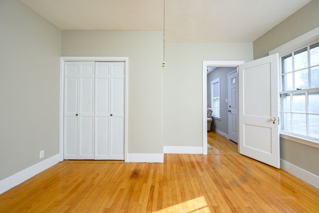 159 High Street Hingham, MA 02043 - Photo 15 of 27 a view of an empty room with wooden floor and a window