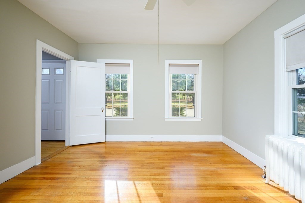 159 High Street Hingham, MA 02043 - Photo 16 of 27 a view of an empty room with wooden floor and a window