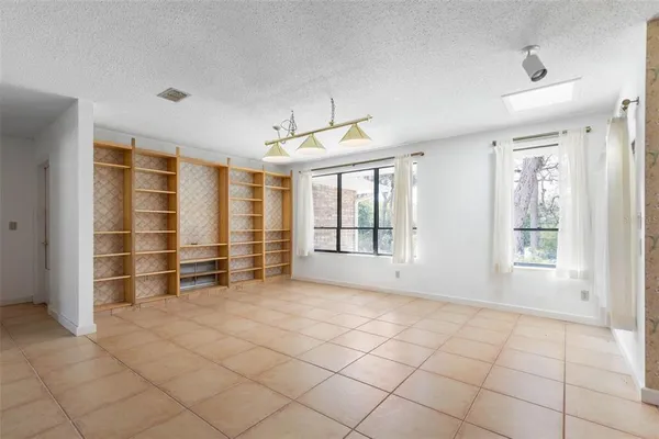 a view of empty room with fireplace and window