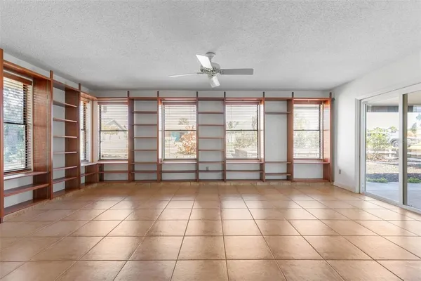 a view of empty room with cabinet and mirrors