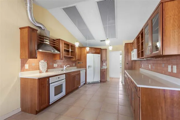 a kitchen with stainless steel appliances a stove and a sink