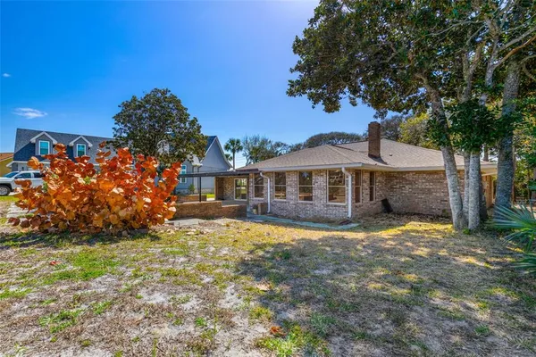 an aerial view of a house with garden space and lake view