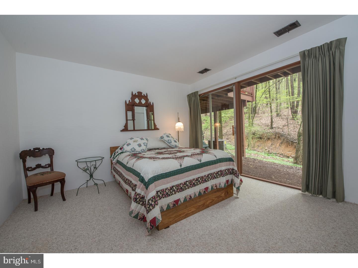597 Upper Weadley Road Wayne, PA 19087 - Photo 13 of 25 a bedroom with a bed and a window