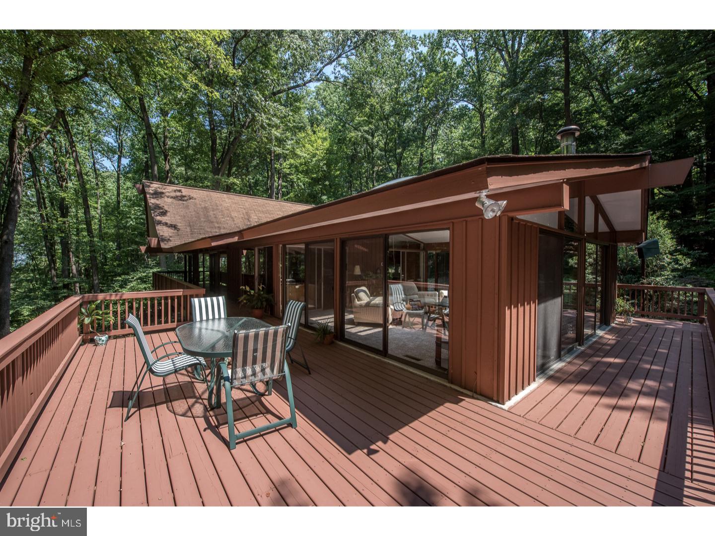 597 Upper Weadley Road Wayne, PA 19087 - Photo 18 of 25 a view of patio with table and chairs with wooden floor and fence