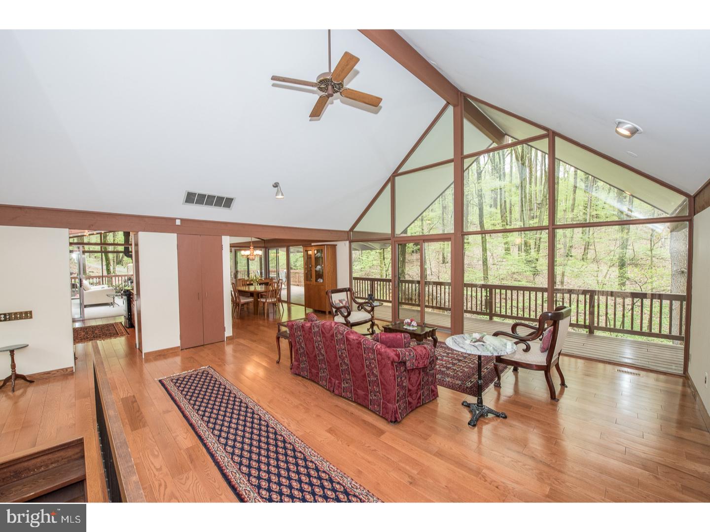 597 Upper Weadley Road Wayne, PA 19087 - Photo 4 of 25 a living room with furniture floor to ceiling window and wooden floor