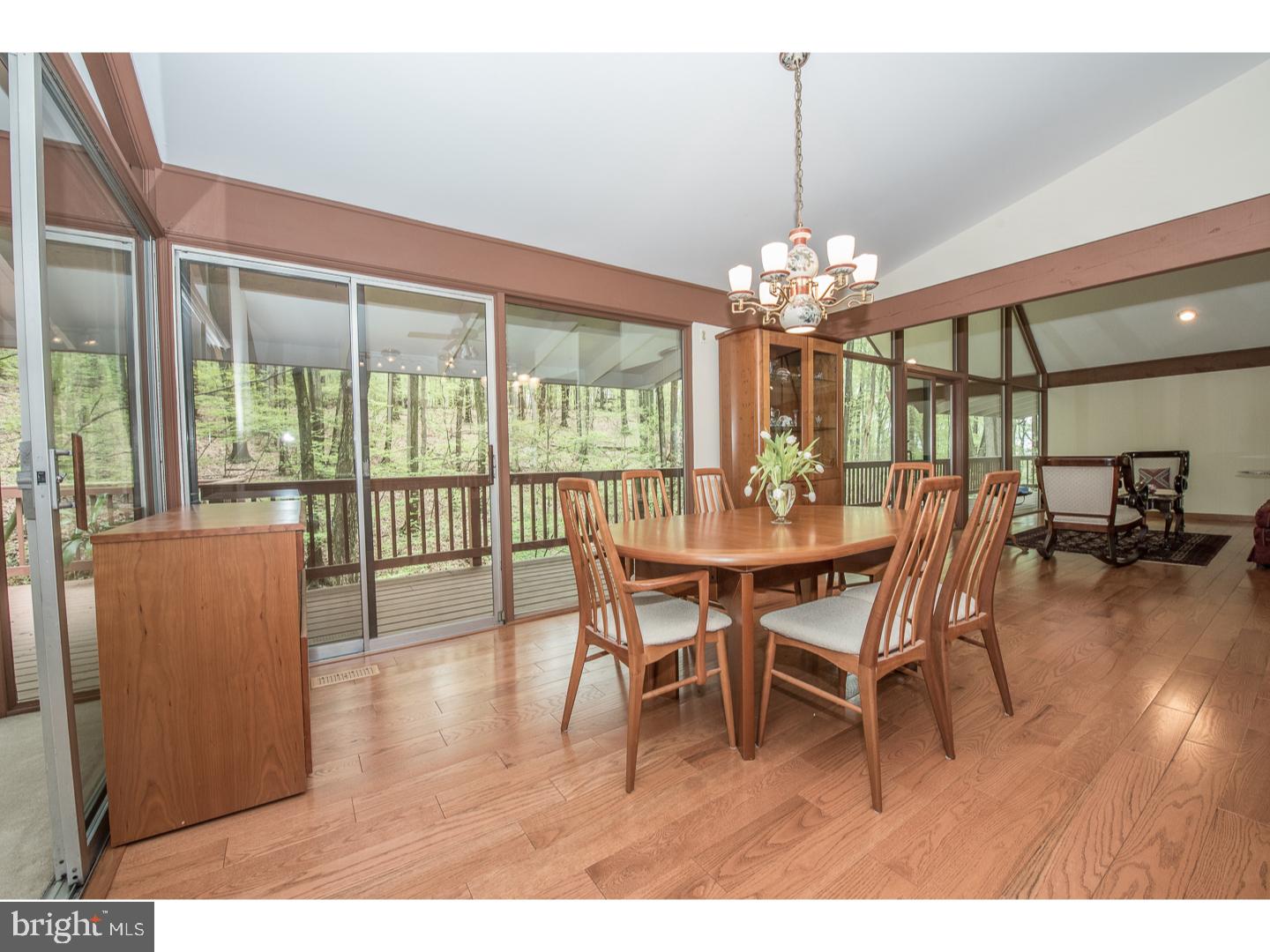 597 Upper Weadley Road Wayne, PA 19087 - Photo 5 of 25 a dining room with furniture a chandelier and wooden floor