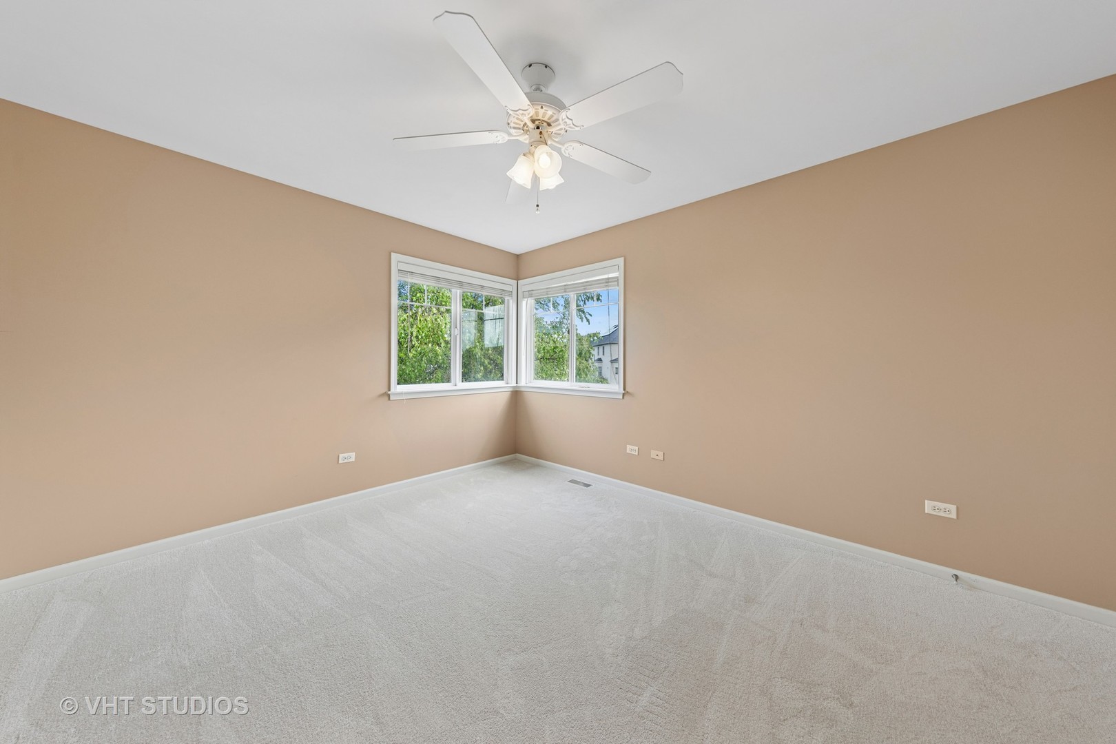 12804 Stellar Lane Plainfield, IL 60585 - Photo 22 of 37 an empty room with a chandelier fan and windows