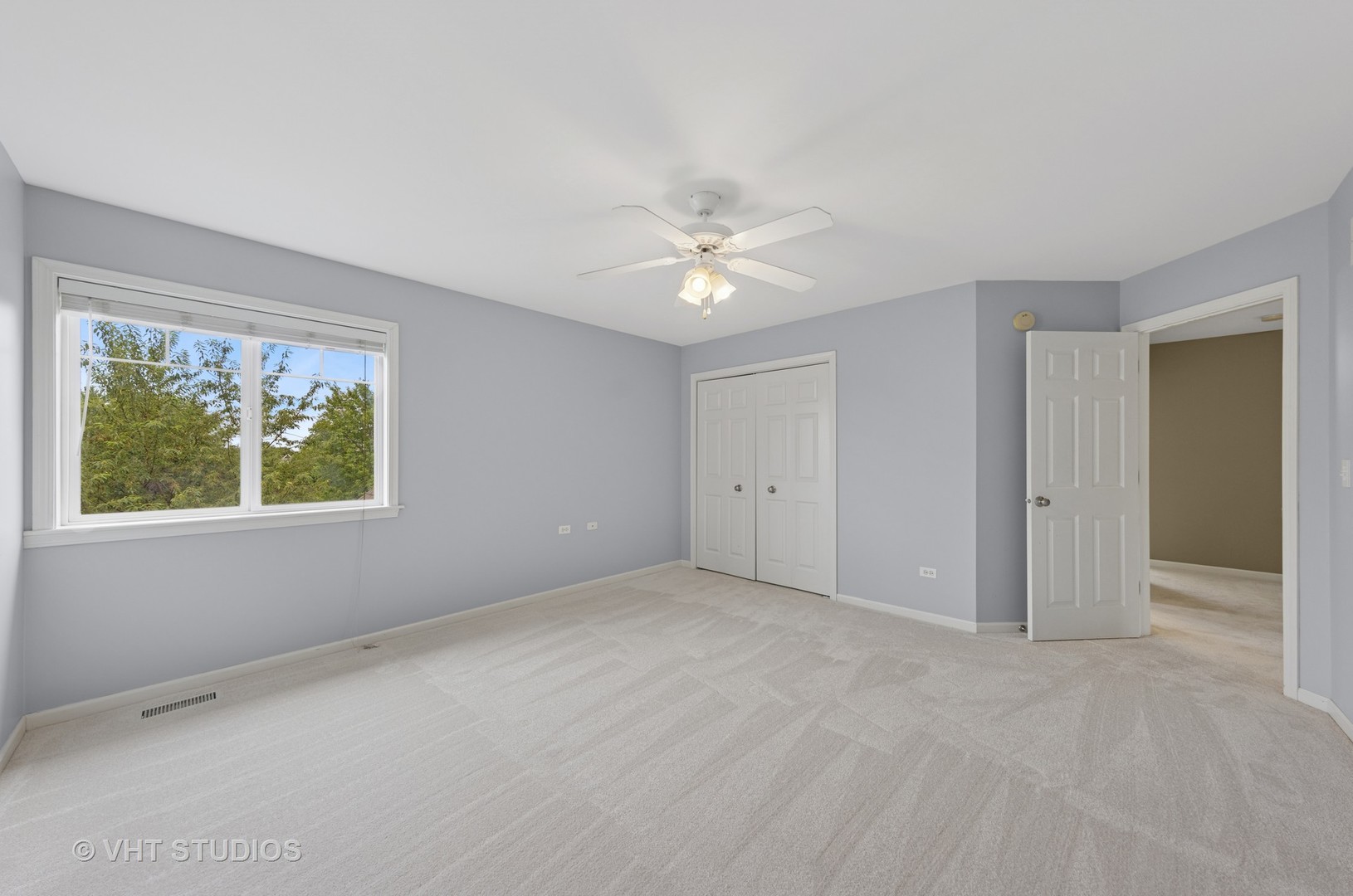 12804 Stellar Lane Plainfield, IL 60585 - Photo 26 of 37 an empty room with a window and a ceiling fan