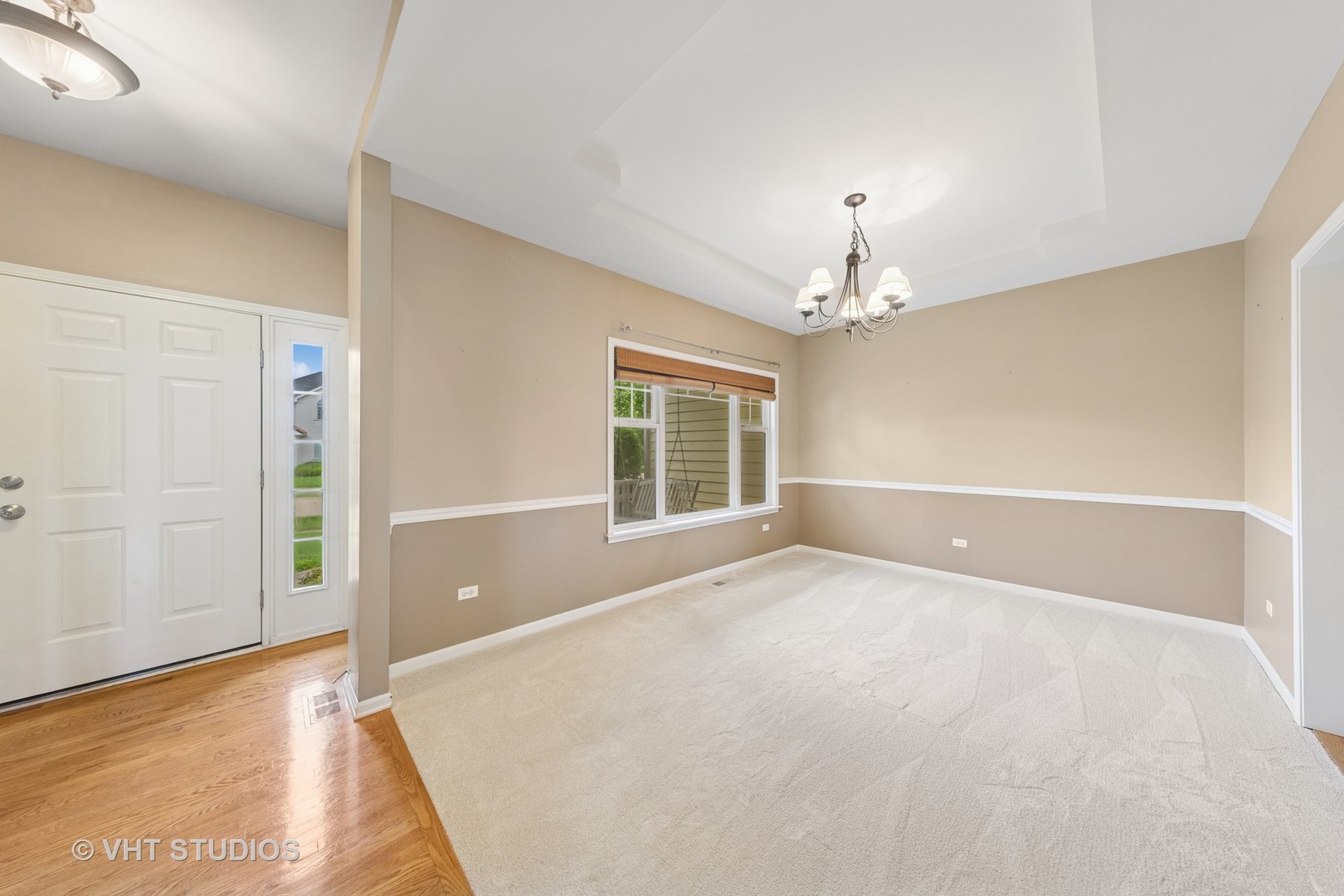 12804 Stellar Lane Plainfield, IL 60585 - Photo 3 of 37 an empty room with windows and chandelier