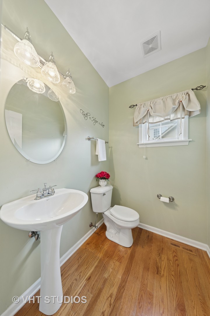 12804 Stellar Lane Plainfield, IL 60585 - Photo 7 of 37 a bathroom with a sink toilet and a mirror