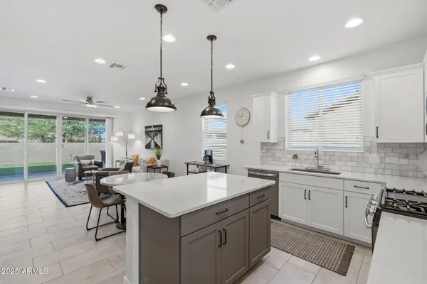 a kitchen with sink stove and cabinets