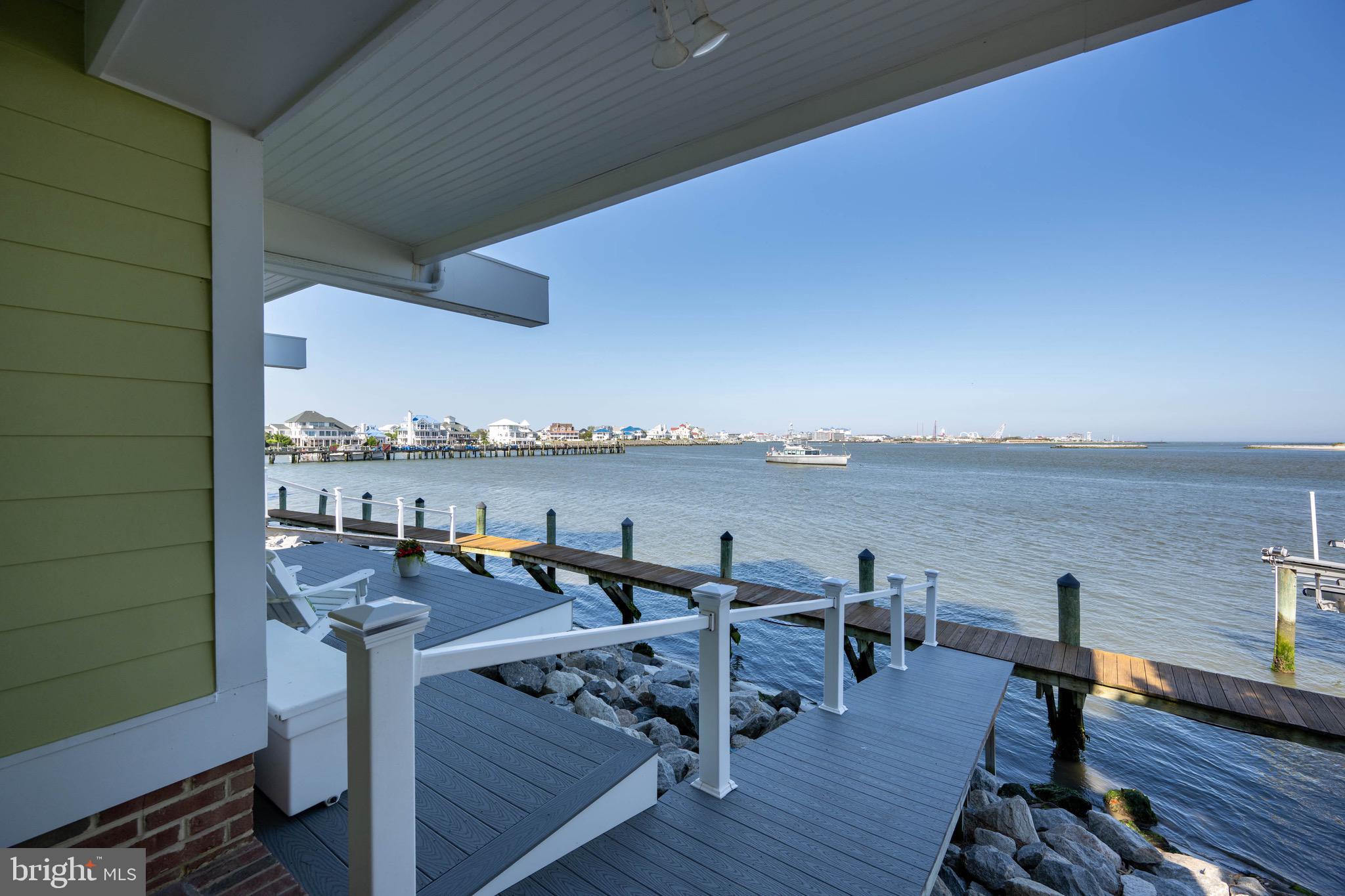 12959 Harbor Road Ocean City, MD 21842 - Photo 49 of 85 a view of a balcony with chairs and wooden floor