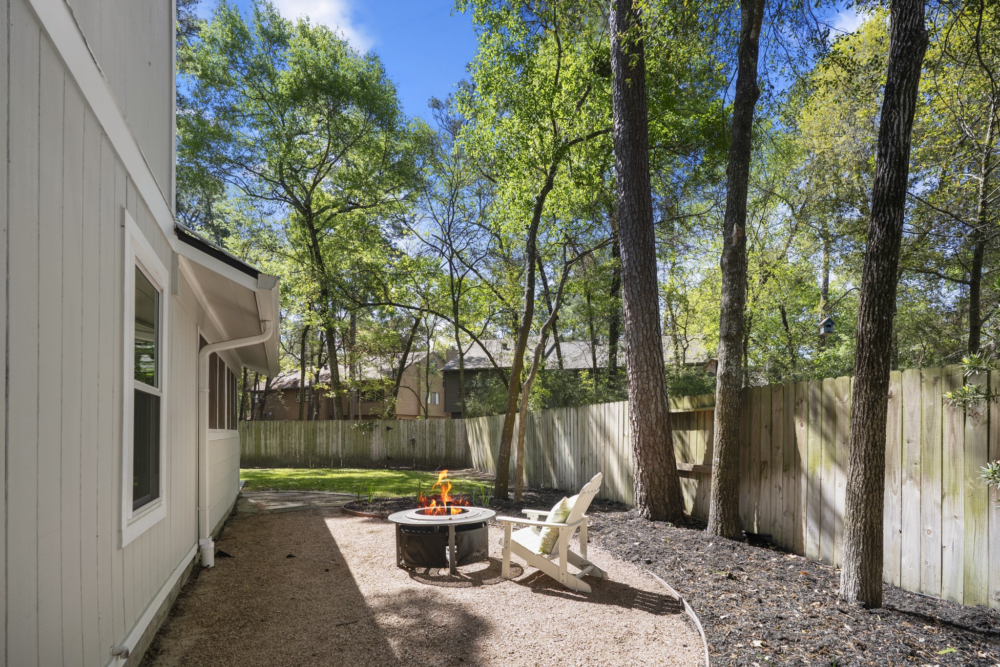 12224 Gun Oak Place Spring, TX 77380 - Photo 33 of 37 Backyard Fire Pit Area Surrounded by Mature Trees