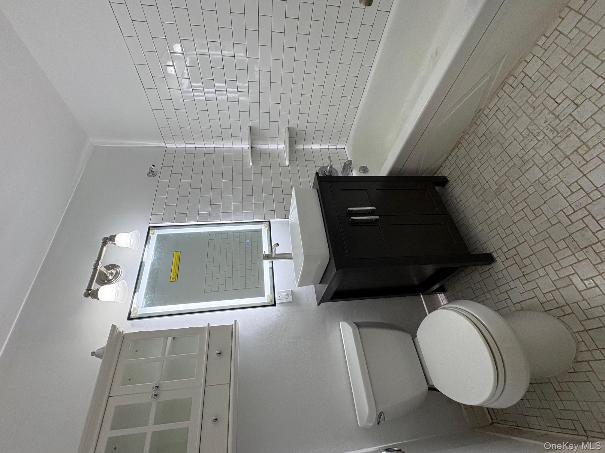 2103 Barclay Manor, Unit 21C Newburgh, NY 12550 - Photo 3 of 7 a bathroom with a sink a toilet and bathtub