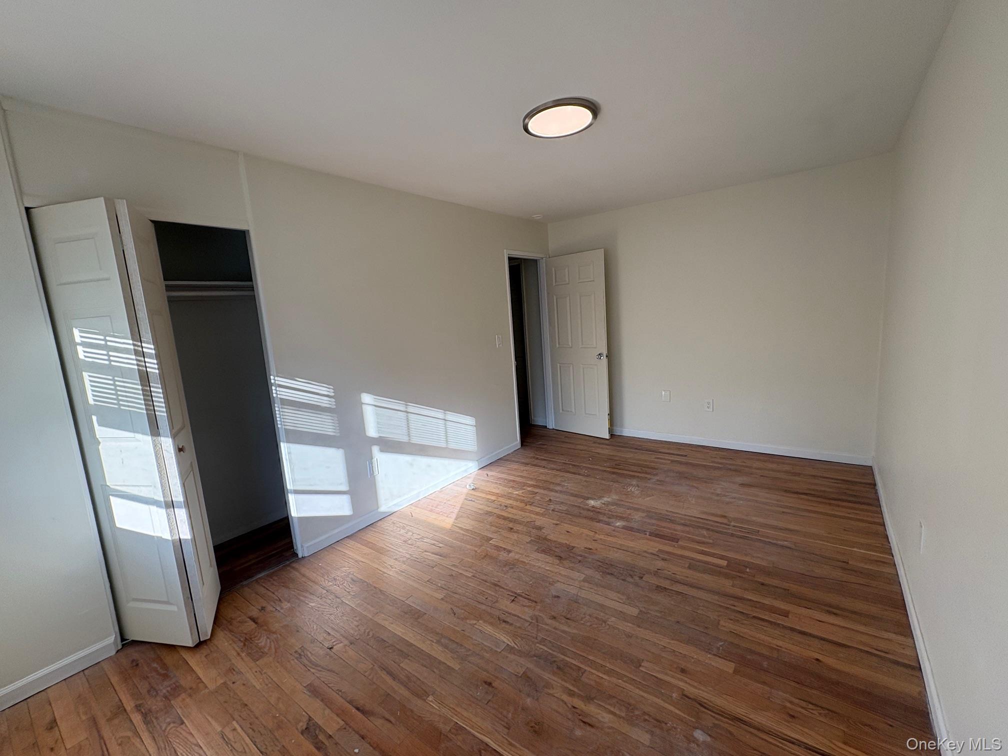 2103 Barclay Manor, Unit 21C Newburgh, NY 12550 - Photo 4 of 7 a view of empty room with wooden floor and fan