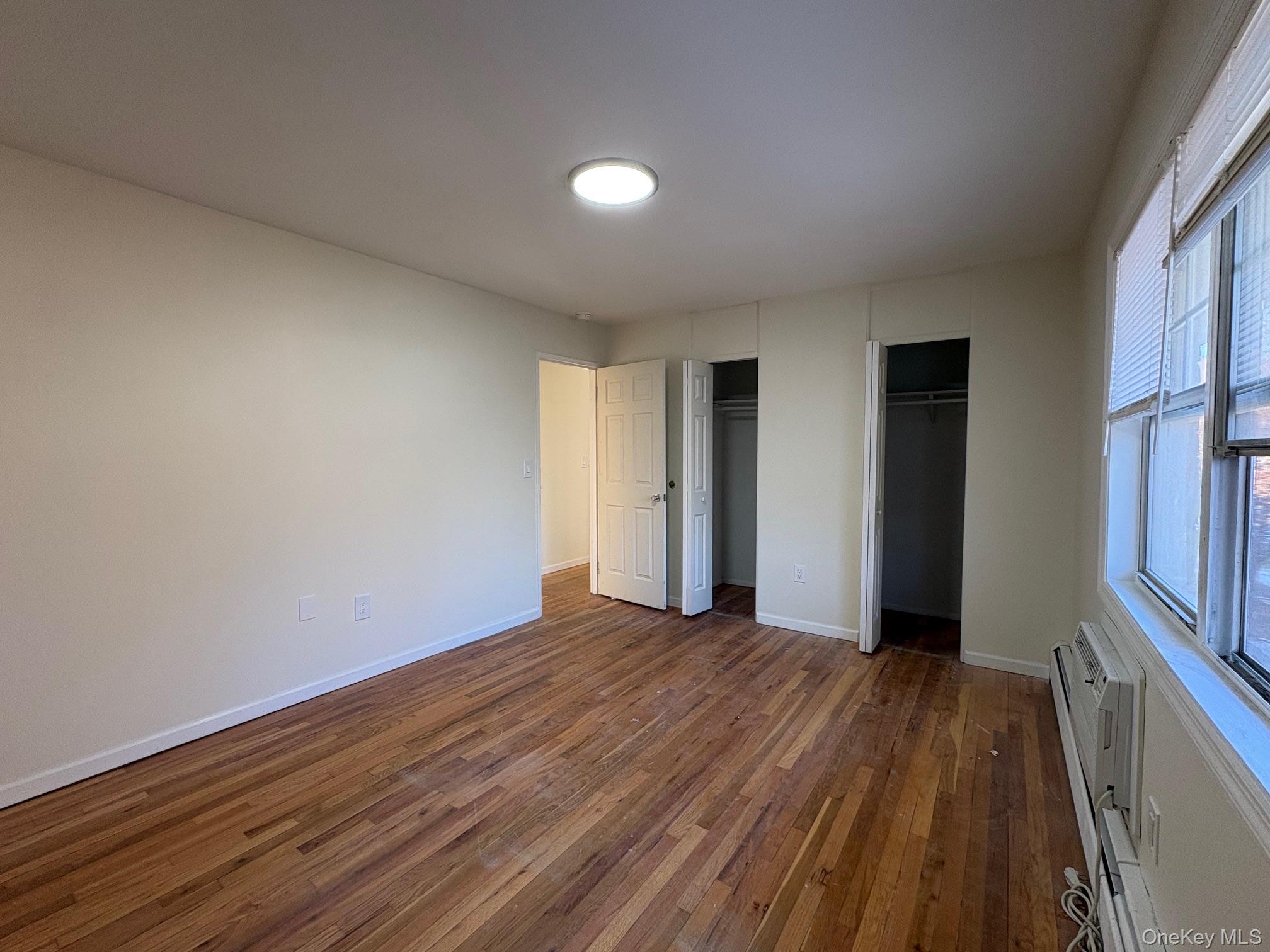 2103 Barclay Manor, Unit 21C Newburgh, NY 12550 - Photo 7 of 7 a view of an empty room with wooden floor and a window