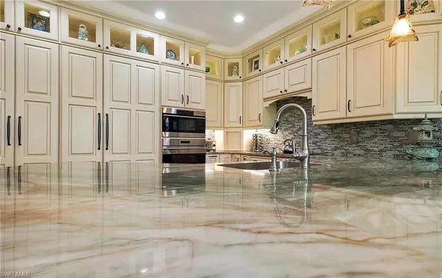 a kitchen with stainless steel appliances granite countertop a stove a sink and a granite counter tops