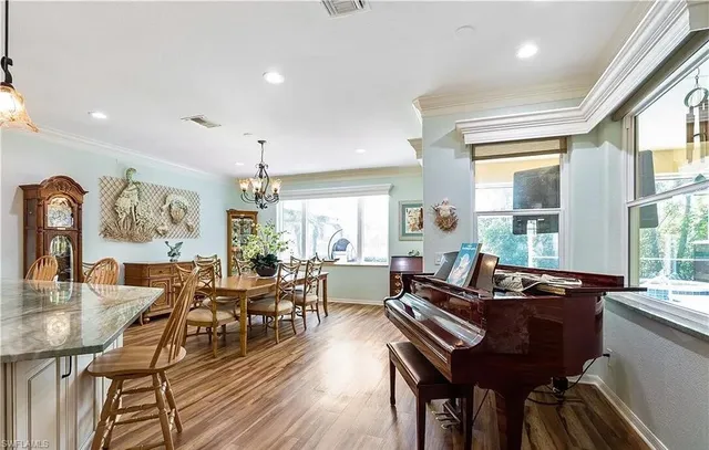 a living room with furniture and floor to ceiling windows