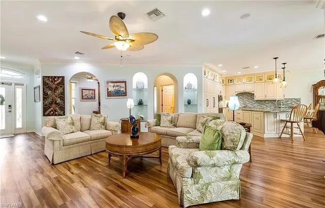 a living room with fireplace furniture and a large window