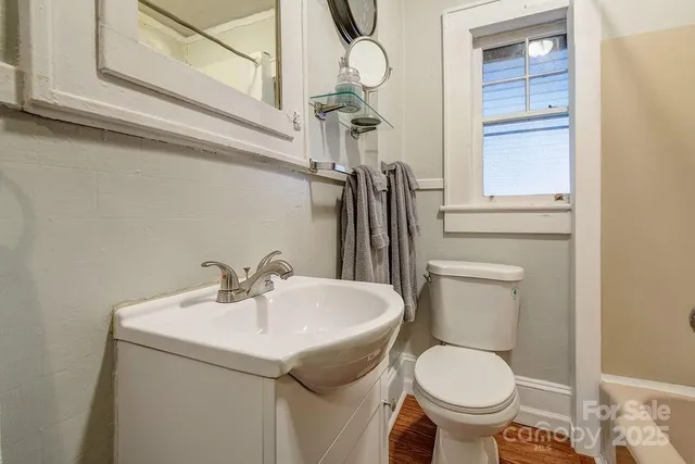 a bathroom with a sink a toilet and mirror