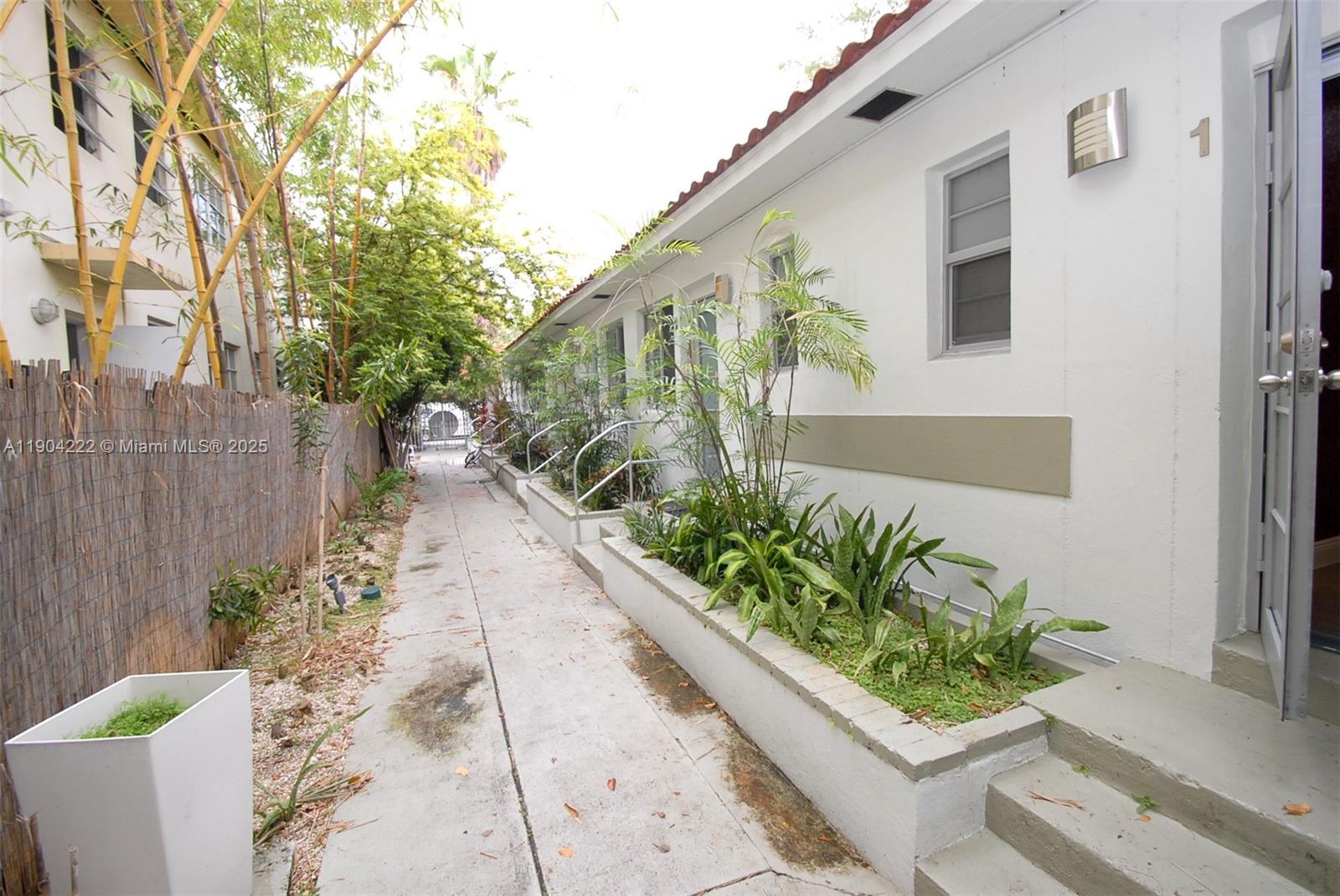 744 Lenox Avenue, Unit 3 Miami Beach, FL 33139 - Photo 12 of 13 a front view of a house with a yard